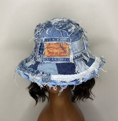 a mannequin head wearing a denim hat with an image of a horse on it