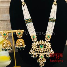 Shaira Long Pacchi Kundan Emerald Statement Necklace/ Rajwadi Ruby Necklace Made in Brass with 22 karat gold plating, Pacchi kundan and semi precious beads Handcrafted To PerfectionLight Weight Choker NecklacePerfect For Indian Weddings And CelebrationsA Beautiful & Memorable Gift for Weddings or engagement.Necklace: 10-12 InchesEarrings: 2.5 InchesEarrings come with push back closure Diwali White Kundan Necklace In 22k Gold, White 22k Gold Kundan Necklace For Diwali, Gold Kundan Chandbali Beaded Necklaces, Kundan Pearl Necklace With Cutdana For Puja, Gold Kundan Beaded Necklace For Puja, Gold Kundan Beaded Necklaces For Puja, Kundan Pearl Necklace With Meenakari For Puja, Traditional White Kundan Necklace In 22k Gold, White 22k Gold Kundan Necklace For Festivals