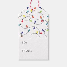 a white gift tag with colorful lights on it