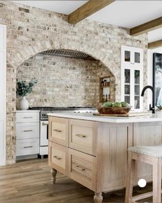 a kitchen with an oven and two stools in front of the counter top area