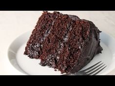 a slice of chocolate cake on a plate with a fork