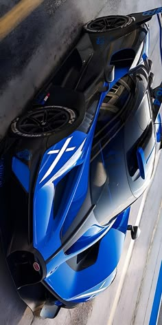 a blue sports car is parked on the street