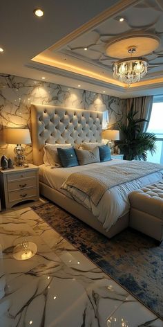 a large bed sitting in the middle of a bedroom next to a window with a chandelier