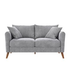 a grey couch with two pillows on top of it and one arm folded back to the side