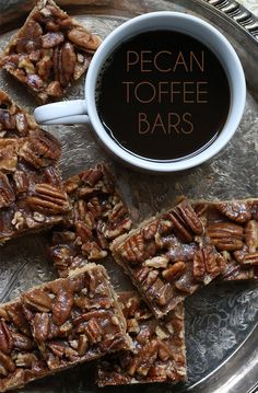 pecan toffe bars on a plate with a cup of coffee