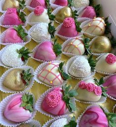 chocolate covered strawberries with pink and gold decorations on them are displayed in a box