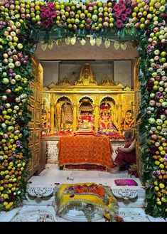 the altar is decorated with flowers and fruit