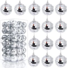 a bunch of disco ball ornaments hanging from the ceiling and in front of a white background