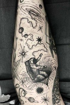 a man's arm with space and stars tattoo on the left side of his leg