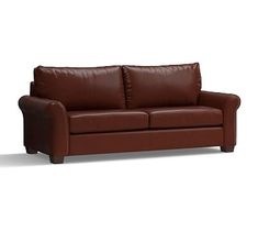 a brown leather couch sitting on top of a white floor