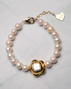 Dress up with our Pearl Flower Girl Bracelet. Made with freshwater pearls and an 18k gold gilded flower charm, this bracelet adds a cute and chic touch to any outfit. Perfect for everyday or any special occasions. 18k gold-plated, freshwater pearl 6" bracelet | 1" extension chain | 8 mm pearls | 20 mm flower charms Multiple sizes are available Handmade in Los Angeles with imported materials Follow these tips to keep your jewelry looking its best! Flower Girl Bracelets, Girl Bracelet, Pearl Flower, Gold Gilding, Flower Charm, Sticker Shop, Fresh Water, Freshwater Pearls, Flower Girl