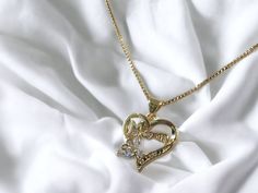 "Surprise your mother with this stunning Mom Heart-Butterfly necklace with chain, laminated in gold. The elegant pendant is crafted with clear Cubic Zirconia stones that are sure to catch everyone's eye. This beautiful necklace is adjustable from 18\" to 20\", with a thickness of 1mm, making it versatile and comfortable to wear. The necklace is perfect for Mother's Day, birthdays or to show your love and appreciation to your loved ones.  The Mom necklace is a perfect gift for various special occ Mama Necklace, Heart Butterfly, Necklace For Mom, Sterling Silver Heart Necklace, Heart Shaped Necklace, Elegant Pendant, Silver Heart Necklace, Mom Necklace, Romantic Gift