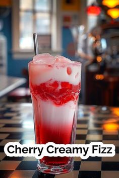 a tall glass filled with ice sitting on top of a checkerboard countertop