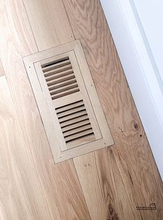 a wooden floor with a vent on it