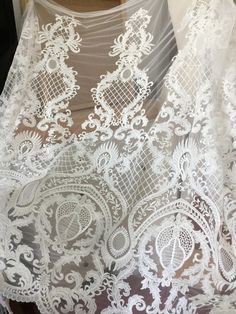 "This stunning Lace Fabric design piece has soft hand feel, It's perfect for weddings, bridal parties, and any events. Shop our large inventory of bridal fabrics. ☆PRODUCT DESCRIPTION : This gorgeous fabric is made on a sheer base with a beautiful vintage star embroidery throughout. The fabric width is approximately 51\" (130cm) Wide. Color: off-white as in picture Material: Rayon, Polyester ☆ PURCHASING INFORMATION: This fabric is sold by the yard and each Qty you enter will represent 1 yard of Elegant Embroidered White Tulle Fabric, Elegant White Embroidered Tulle Fabric, Embroidered Lace Tulle Fabric For Wedding, Embroidered Tulle Lace For Wedding, Wedding Lace With Embroidered Tulle, Embroidered Lace Wedding Dress For Mother Of The Bride, Intricate Lace Embroidery Fabric For Brides, White Tulle Fabric With Intricate Embroidery For Ceremony, Fitted Embroidered Fabric With Lace Patchwork For Wedding