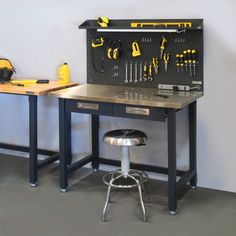 a workbench with tools on it and stools in front of the table