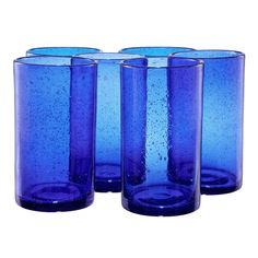 four blue glass vases sitting next to each other