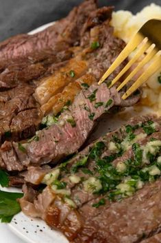 a fork is stuck into some meat on a plate