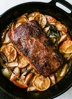 a pan filled with meat and vegetables on top of a table