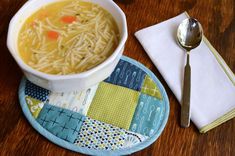 a bowl of soup and a spoon on a table