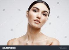 a beautiful woman with black hair and brown eyes looking at the camera, on a white background