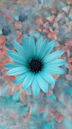 a large blue flower sitting on top of a green and red plant with lots of leaves