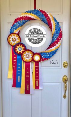 a wreath made out of ribbons hanging on the front door