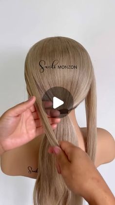 a woman with long blonde hair is shown using scissors to cut the bangs on her head