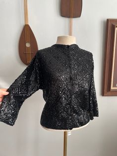 "50s/60 Laura Aponte Black Sequin Cardigan I can't imagine a more beautiful cardigan. This wool cardigan is fully hand-sequined in a diamond pattern. The center of the diamonds are adorned in black, plastic gems. The front of the cardigan fastens with black, plastic buttons. From what I've read, Laura Aponte worked as a designer for Schiaparelli before starting her own line in the 50s. The Met Costume Institute currently has a few of her dresses on display. She specialized in sequined knitwear. Fitted Sequin Evening Cardigan, Glamorous Fitted Evening Cardigan, Vintage Evening Cardigan For Winter, Vintage Winter Evening Cardigan, Vintage Long Sleeve Cardigan For Evening, Vintage Cardigan For Evening In Winter, Vintage Winter Cardigan For Evening, Taken Pictures, Sequin Cardigan