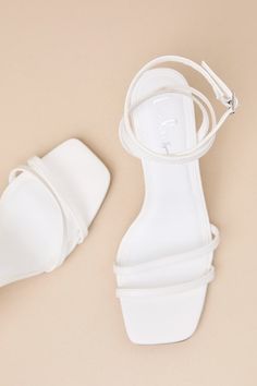 The Lulus Tinslie White Strappy High Heel Sandals are sleek, modern, and ready to be styled with your most fabulous outfits this season! Smooth faux leather shapes these must-have heels that feature a square-toe bed, two slender toe straps, and matching straps that sprout from the sides to wrap and secure above the ankle with a silver buckle. A chunky, sculpted block heel lends an eye-catching finish to this chic design. 4" Wrapped Block Heel. Cushioned Insole. Rubber Sole Has Nonskid Markings. Chic Party Block Heels With Single Toe Strap, Chic Block Heels With Single Toe Strap For Party, Sleek Summer Heels With Buckle Closure, Sleek High Heel Block Heels For Summer, Sleek Summer Block Heels With Heel Strap, Sleek Summer Heels With Stacked Heel, Sleek Summer High Block Heels, Sleek Summer Block Heels With Wrapped Heel, White Strappy High Heels