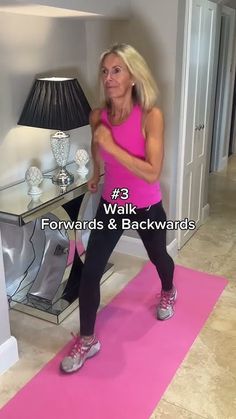 a woman in pink shirt and black leggings doing exercises