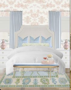 a white bed sitting in a bedroom next to a window with blue drapes on it