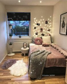 a bed room with a neatly made bed and pictures on the wall