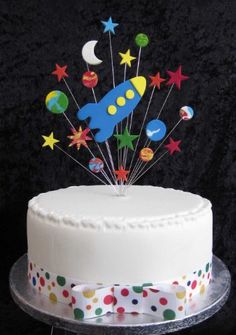 a white cake with stars and rockets on top