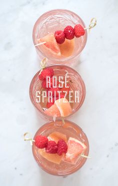 three glasses filled with fruit on top of a table