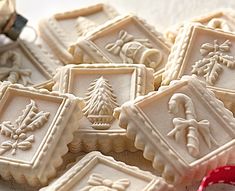 decorated cookies with frosting on top of each other in different shapes and sizes, sitting on a table