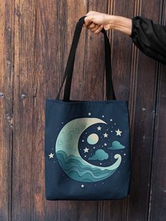 "🎉 Discover Your Perfect Tote Bag Companion 🎉 Elevate your everyday style with our stunning, high-quality tote bags - a perfect blend of fashion and functionality. Designed with love and crafted to perfection, these tote bags are a must-have accessory for any occasion. 🌙⭐ Sail Into the Night with Your Celestial Companion! ⭐🌙 Invite the magic of the moon and stars into your everyday life with our Celestial Tote Bag. This tote bag features a captivating celestial design in a soothing sleepycore style, sure to inspire sweet dreams and positive vibes. Adorned with a cute, cartoonish moon, swirling vortexes, and the mysterious night sky, it's the perfect tote for tarot card enthusiasts, zodiac followers, and witchy individuals. Crafted with a love for traditional oceanic art, this aesthetic Artistic Canvas Bag With Large Capacity For Daily Use, Artistic Canvas Bag For Daily Use With Large Capacity, Artistic Large Capacity Canvas Bag For Daily Use, Artistic Blue Bag For Everyday Use, Artistic Blue Bags For Everyday, Artsy Blue Bags For Everyday Use, Artistic Blue Tote Shoulder Bag, Artsy Blue Bag For Daily Use, Artistic Blue Shoulder Bag For Everyday Use