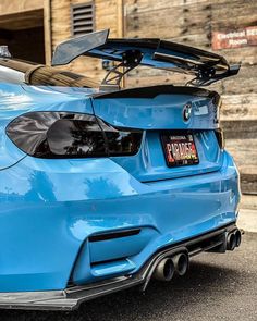 the rear end of a blue bmw car