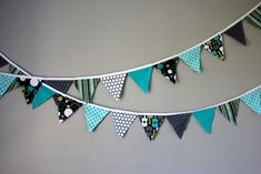 a blue and white bunting with owl decorations on the top, along with polka dots