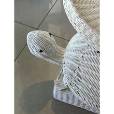 two white wicker chairs sitting on top of a tile floor