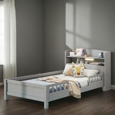 a bedroom with a white bed and gray walls