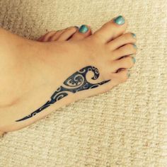 a woman's foot with a tattoo design on the top and bottom of it