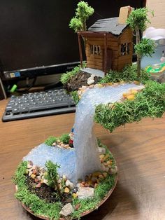 a cake shaped like a tree with a house in the middle on top of it