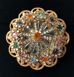 "Here is a rare and very pretty vintage brooch designed by Frank Hess, head designer for Miriam Haskell. This brooch bears the designer's highly sought after horse shoe signature which was only briefly used (1948 - 1950), making this a highly collectible piece. The brooch is beautifully crafted in a gorgeous floral pattern that incorporates glittering rhinestones in multiple colors, shimmering clear crystal rose montees and smooth translucent grey-blue stones. The stone setting is in an enchanti Victorian Jeweled Wedding Brooches, Vintage Multi-stone Brooches For Formal Occasions, Vintage Rhinestone Brooches For Vintage Events, Victorian Jeweled Brooches For Party, Victorian Multi-stone Wedding Brooches, Antique Jeweled Brooch For Wedding, Antique Multi-stone Brooches For Wedding, Vintage Multi-stone Gold Brooches, Vintage Gold Multi-stone Brooches