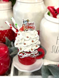 a red cup filled with whipped cream on top of a table