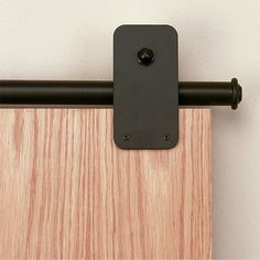 a close up of a wooden door with a black handle on the top and bottom