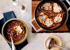 a table topped with two pans filled with food