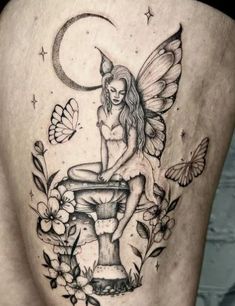 a woman's thigh with a fairy sitting on top of a fountain and butterflies around her