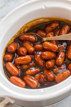 the beans are cooked and ready to be eaten in the crock pot with a wooden spoon