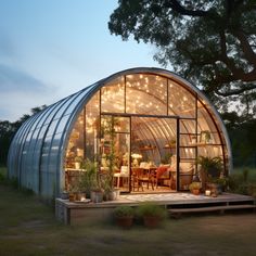 a glass house with lots of lights inside it's walls and windows on the outside